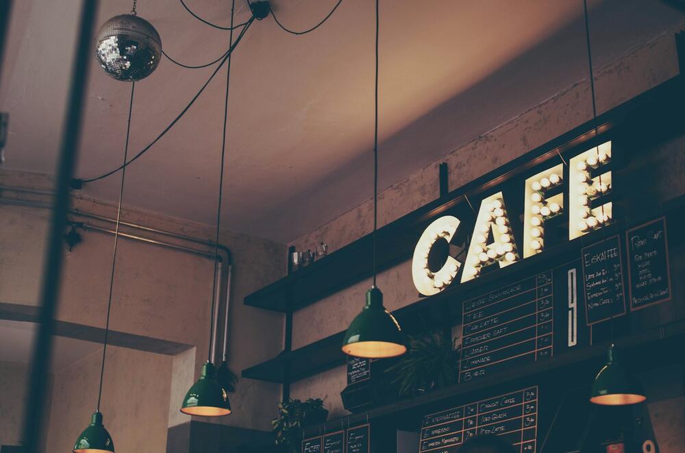 Café storefront with a lit CAFE sign
