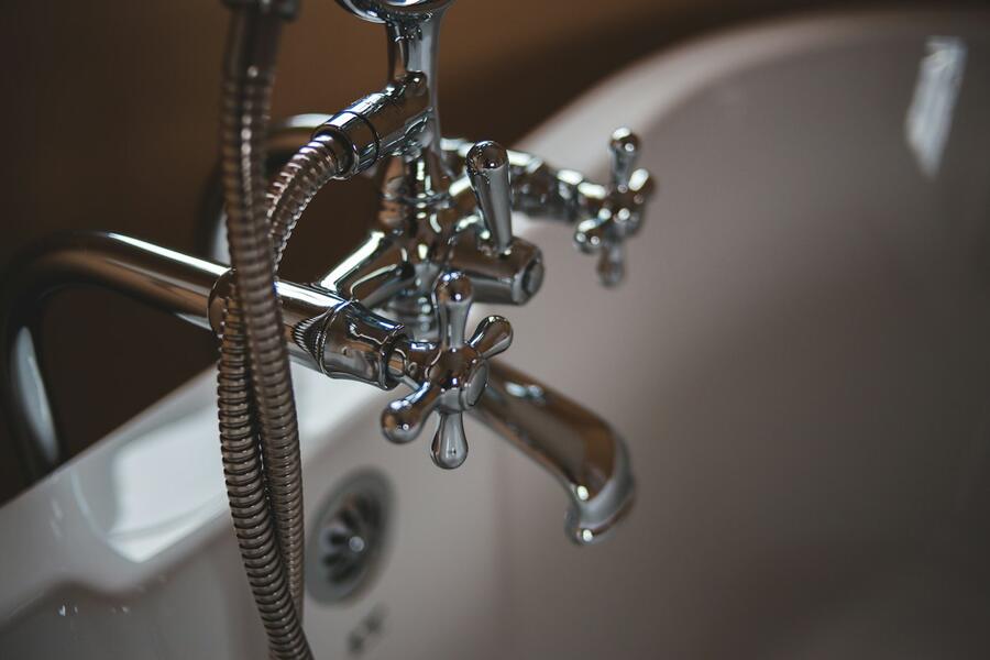 Chrome faucet over a white sink