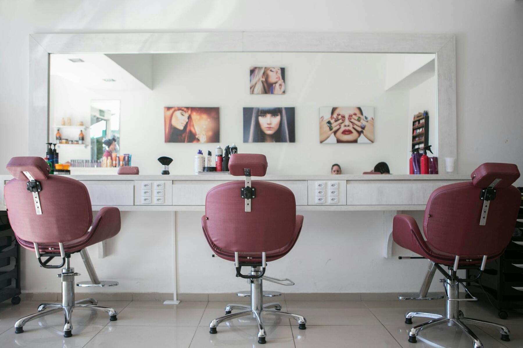 Elegant salon with blush chairs and round mirrors