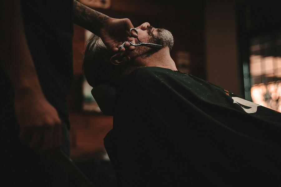 Barber giving a client a straight-razor shave